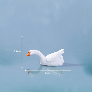 White goose bowing it’s heat to the left miniature